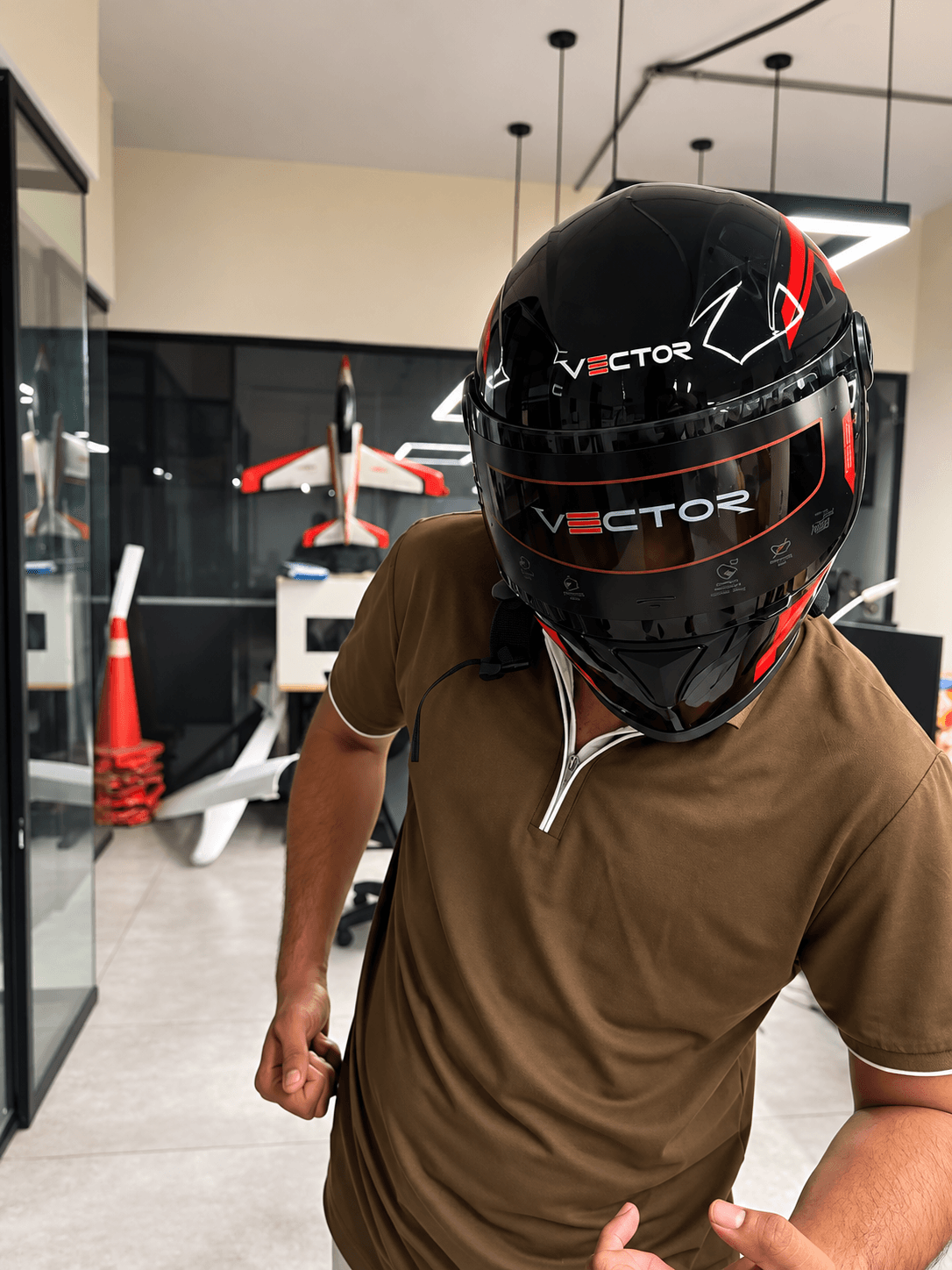 Front view of a rider wearing a black and red Vector full-face helmet