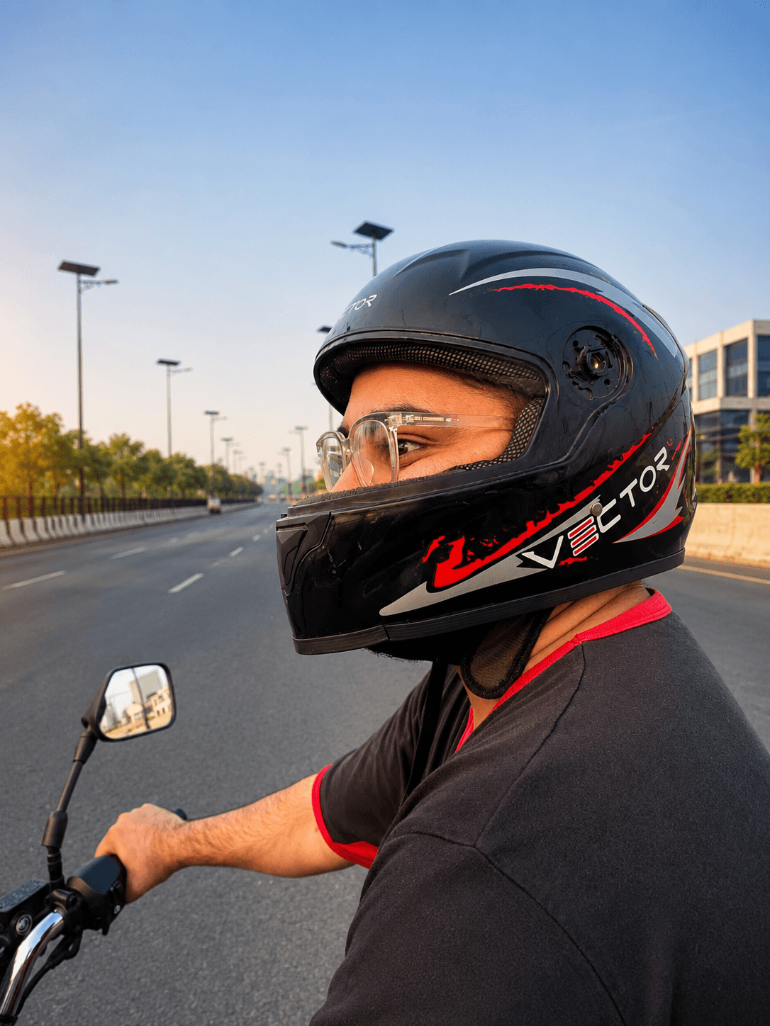 Vector Red Lightning full-face helmet worn while riding on a city road