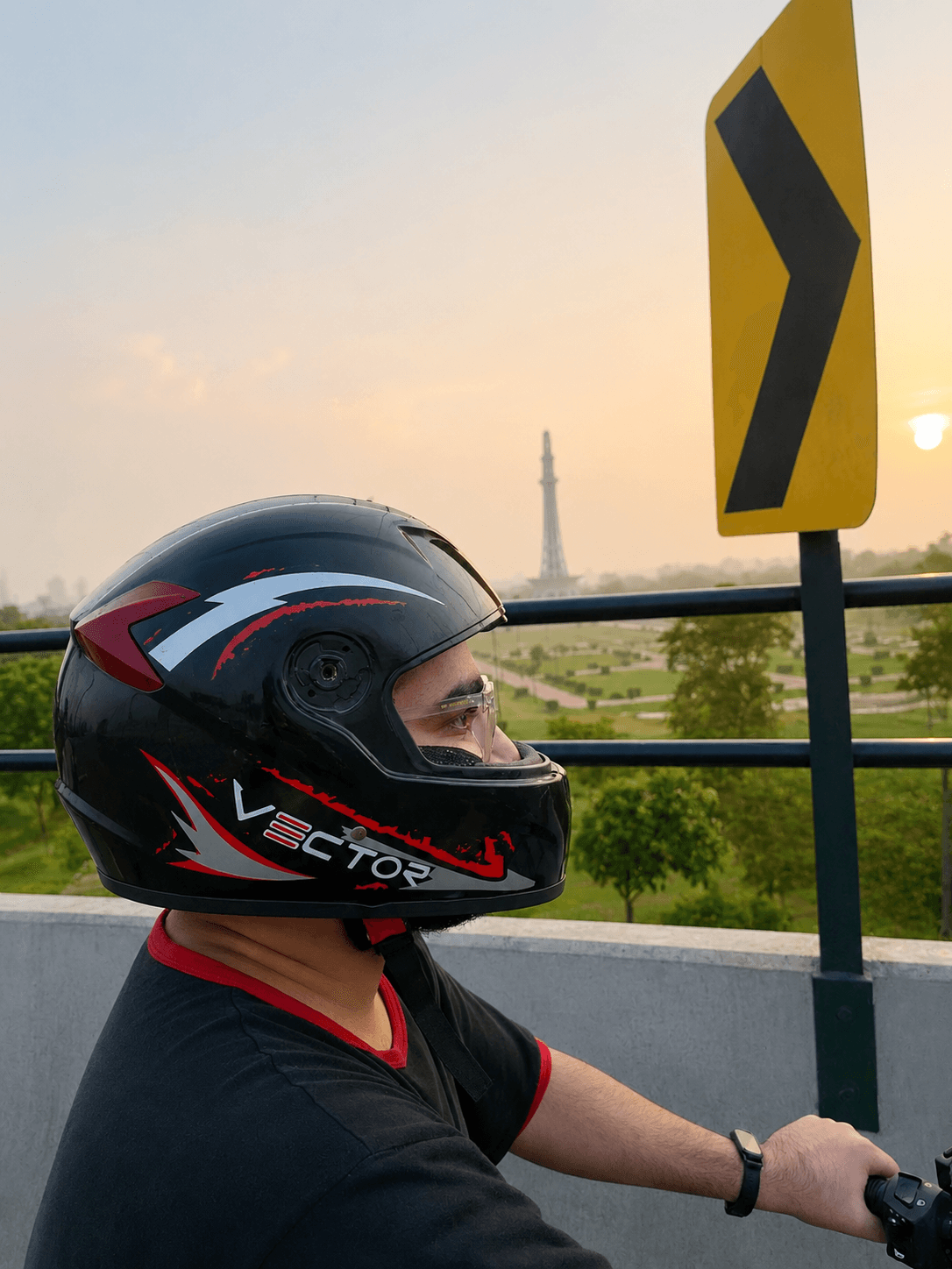 Vector Red Lightning motorcycle helmet side view with Minar-e-Pakistan in background