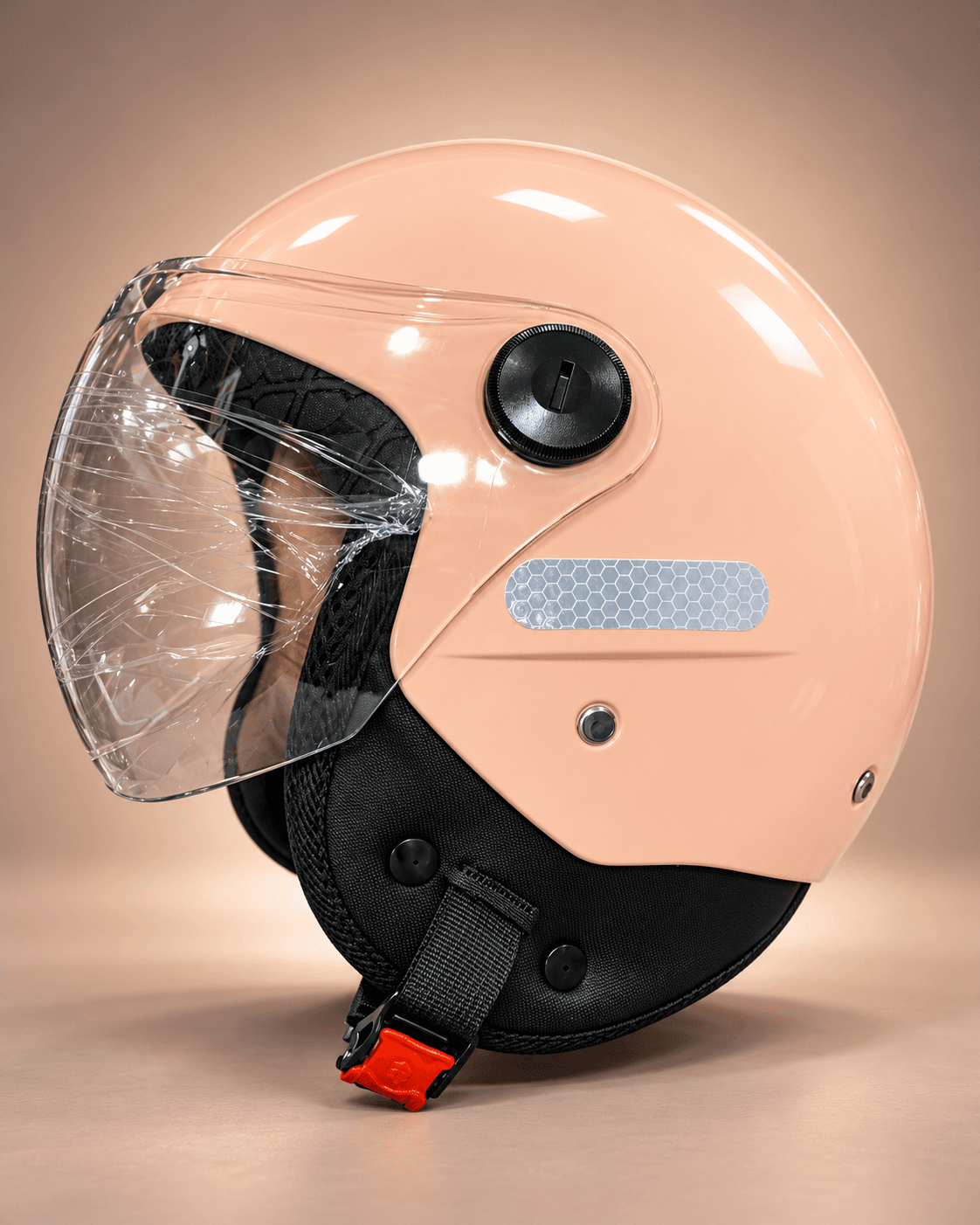 Peach open-face scooty helmet with clear visor and chin strap, side view